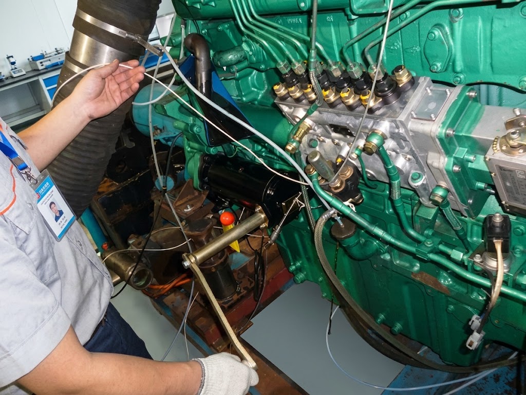 Technician operating CQStart manual spring starter mounted on a diesel engine